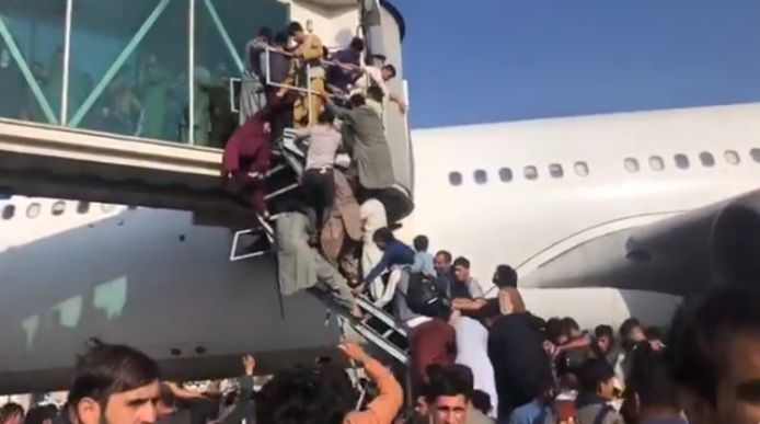 Thousands of Afghans have breached the runway in an attempt to flee their country after the Taliban seized power.