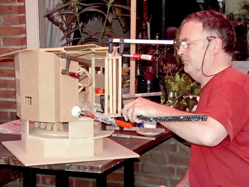Theo Mulder puts the finishing touches on a scale model of the telescope.