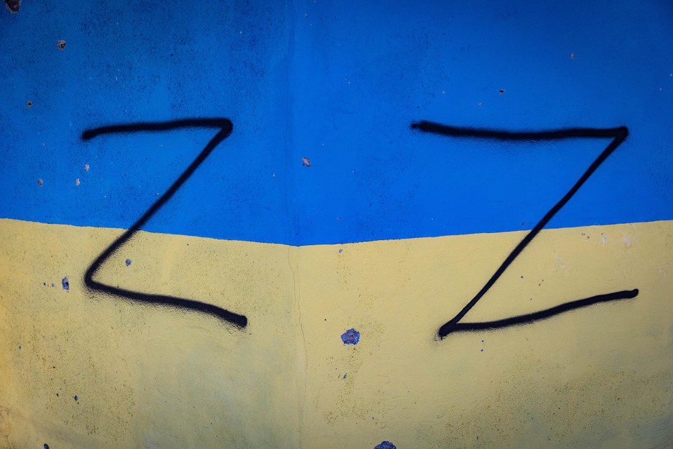The Russians painted the Z symbol as a war sign on the wall with the Ukrainian flag. 