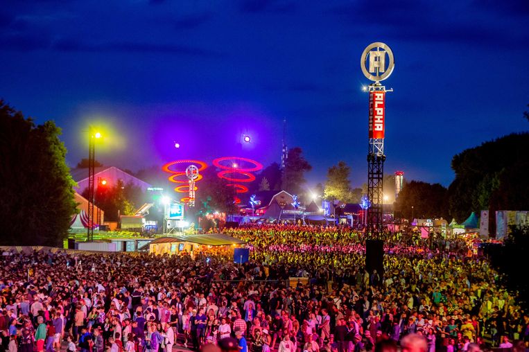 Visitors walk to the Stromae Show on the last day of the three-day music festival.  ANP . image