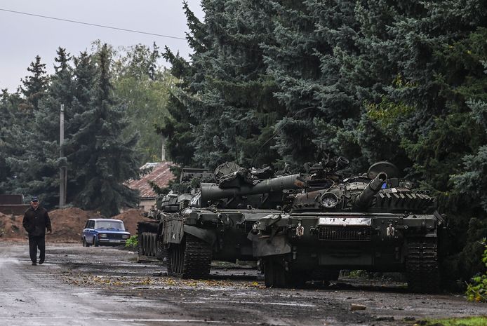 A civilian walks past several abandoned Russian tanks in Kramatorsk.  Photo from October 1.