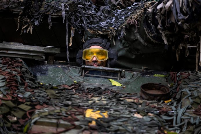Close-up view of the image above.  A Ukrainian mechanic tests a repaired Russian tank in a forested area outside Kharkiv.  Photo from September 26.
