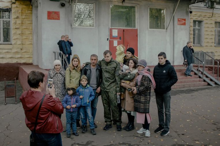 Recruits pose for a photo with their relatives at a recruitment agency in Moscow.  New York Times photo