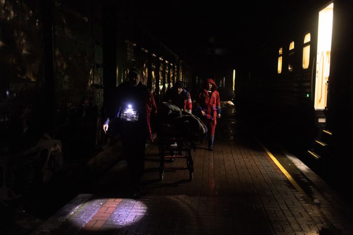 Medical staff assist a Kherson resident on an evacuation train to Kyiv after dark.  Picture from Friday.