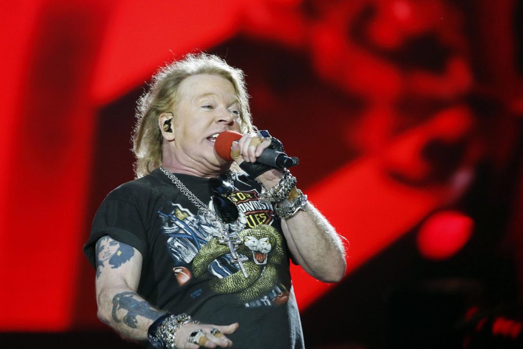 Guns N' Roses fan puts mic in her face, singer Axl Rose replies: "We've been doing this for 30 years, but we're going to stop now"