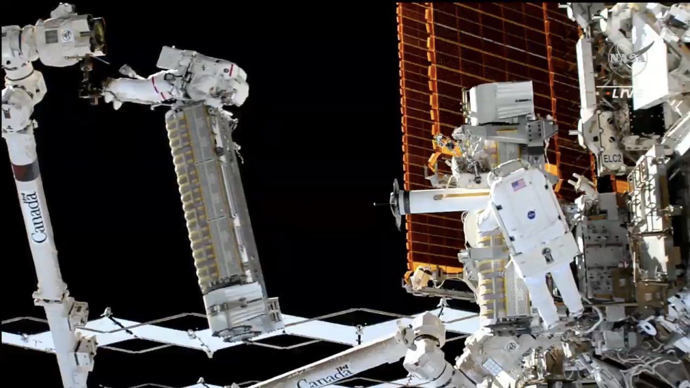 Astronauts install a new solar array outside the International Space Station